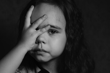 Sad girl holding her face with her hand black and white photo