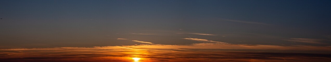 Picture of dramatic and colorful sky with sun during sunset