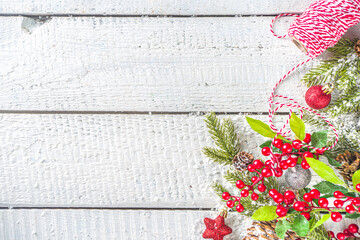 Christmas and New Year greeting card background. Xmas backdrop with fir tree branches, decoration and snowfall on wooden white board