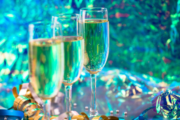 Detailed photo of colorful champagne glasses with pearls, glitter, ribbons and ornaments. Selective focus - extremely shallow depth of field.