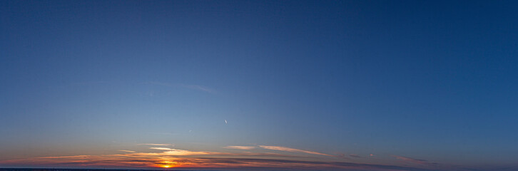 Picture of dramatic and colorful sky with sun during sunset