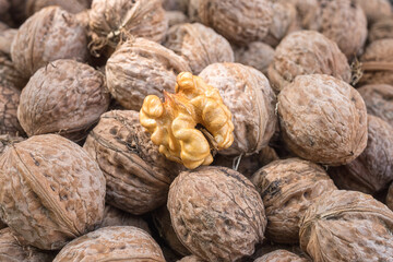 Walnut, a lot of ripe nut fruits (juglans regia), tasty and healthy organic food, natural background