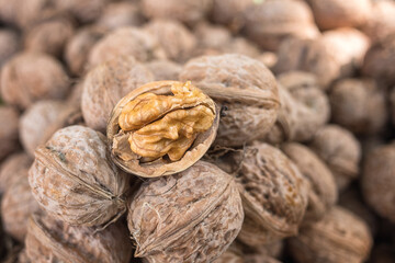 Walnut, a lot of ripe nut fruits (juglans regia), tasty and healthy organic food, natural background