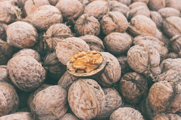 Walnut, a lot of ripe nut fruits (juglans regia), tasty and healthy organic food, natural background