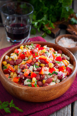 salad with red beans, corn and bell peppers in a wooden salad bowl, selective focus