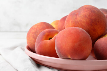 Plate with sweet peaches on table, closeup