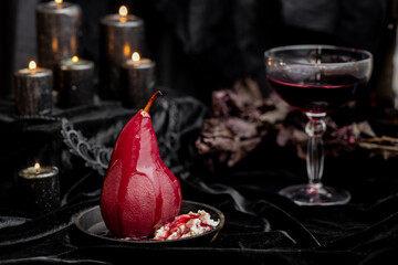 Red wine poached bloody gothic Halloween pears with cream, wine & candles