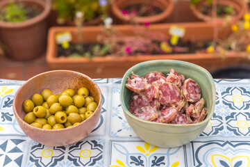 Dishes with olives and homemade salchichon