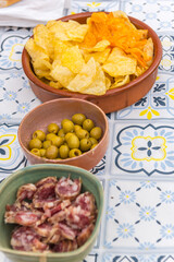 Dishes with olives and homemade salchichon