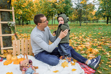 Father and son in the autumn park. active games.