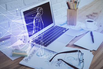 Desktop computer background in office and start up theme hologram drawing. Double exposure. Startup concept.