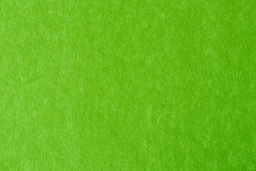 Bright green colored paper showing texture and light gradient.