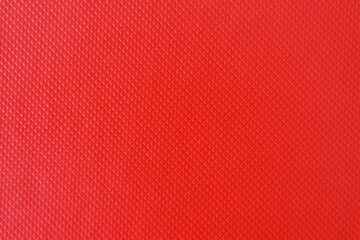 Tax file folder scaly red texture background, macro photo. Texture of a red folder for paper. Red cover texture. Red background