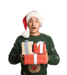 Surprised man in Santa hat and with gift boxes on white background