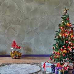 The interior of the New Year, fir tree and gift. Grey stone wall background.