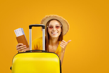 Happy woman in sunglasses and summer hat showing thumb up