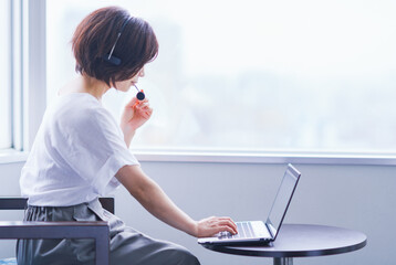 Japanese middle aged woman works online at hotel