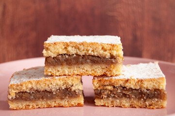 Three apple cake slices as triangle, one on top of the others two, front view