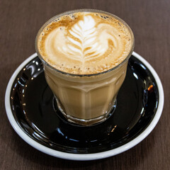 Closeup of a Glass of Coffee Latte on a wooden table in a Sydney Cafe