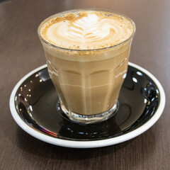 Closeup of a Glass of Coffee Latte on a wooden table in a Sydney Cafe