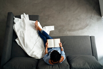 relaxed reading woman sitting on the sofa at home. indoor lifestyle