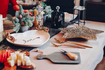 Holiday table setting with Christmas decoration background. New Year eve concept