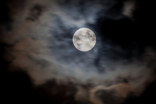 Close up picture of the shiny full moon with cirrostratus clouds