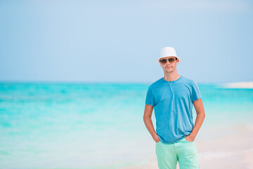 Young man on the white beach on vacation