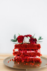 cut cake red velvet with fresh flowers on a gold tray