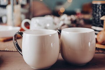 Close up of white mugs of hot drinks. Copy space. New Year eve concept