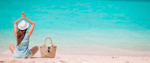 Young fashion woman in green dress on the beach