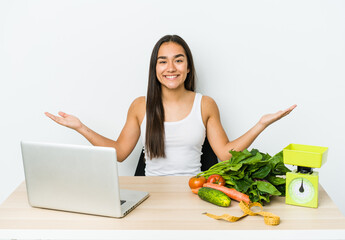 Young dietician asian woman isolated on white background showing a welcome expression.