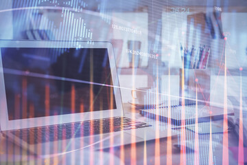 Stock market graph and table with computer background. Double exposure. Concept of financial analysis.