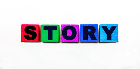 The word STORY is written on colorful cubes on a light background
