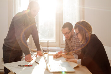 Three colleagues working from home on a project.