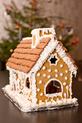 Gingerbread house with snow covered sugar glaze roof.