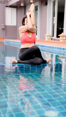 Asian woman yoga breathing and meditation alone at swimming pool at home. Outdoor exercise and...