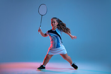 Fototapeta na wymiar Energy. Beautiful dwarf woman practicing in badminton isolated on blue background in neon light. Lifestyle of inclusive people, diversity and equility. Sport, activity and movement. Copyspace.