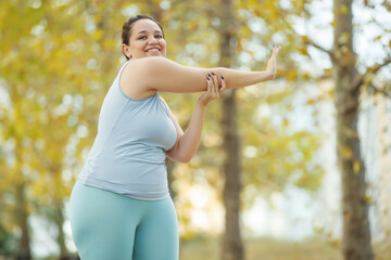 Fat woman and sports. Does exercise for weight loss in the fresh air. High quality photo. - 385042149