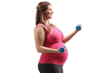 Happy pregnant woman in a pink top exercising with dumbbells
