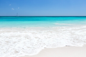 Caribbean beach with turquoise water and blue sky