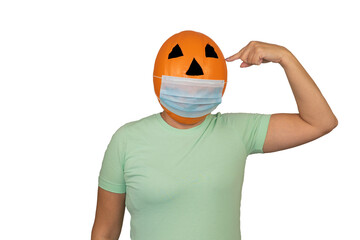 Halloween pumpkin in a medical mask. Surgical protective mask. woman with orange evil mask. celebrating Halloween in the period of the pandemic coronavirus. Jack lantern mask from a basketball.