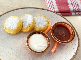cheesecakes with sour cream and strawberry jam. tasty breakfast. Top view