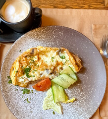 Fried omelet with chicken and mushrooms, with fresh vegetables. Top view