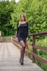 Obraz premium beautiful european young woman posing in summer park