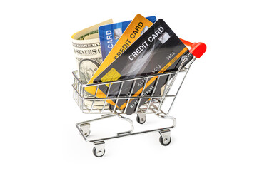 Credit card and US dollar banknotes in shopping cart isolated on white background, finance concept.
