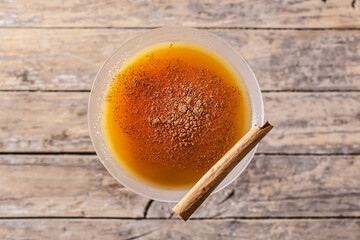 Pumpkin cocktail in glass Pumpkin cocktail in glass on wooden table. Top view