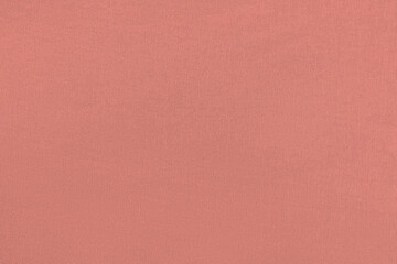 Orange pink homogeneous background with a textured surface, fabric.