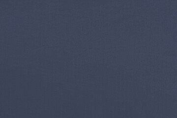 Dark blue homogeneous background with a textured surface, fabric.