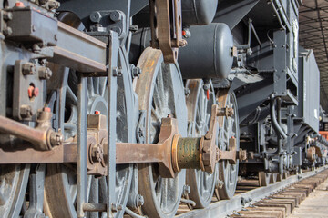 The old iron railway steam locomotive wheels and rods closeup detail